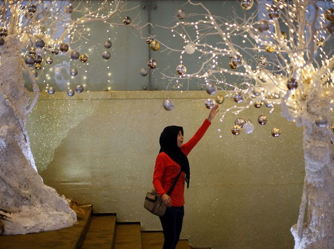 An Indonesian Muslim girl touches Christmas decorations at a shopping mall in Jakarta, Indonesia, 20 December 2012. Business centers and shopping malls were decorated for the upcoming Christmas celebrations. EPA/MAST IRHAMAn Indonesian Muslim girl touches Christmas decorations at a shopping mall in Jakarta, Indonesia, 20 December 2012. Business centers and shopping malls were decorated for the upcoming Christmas celebrations. EPA/MAST IRHAM