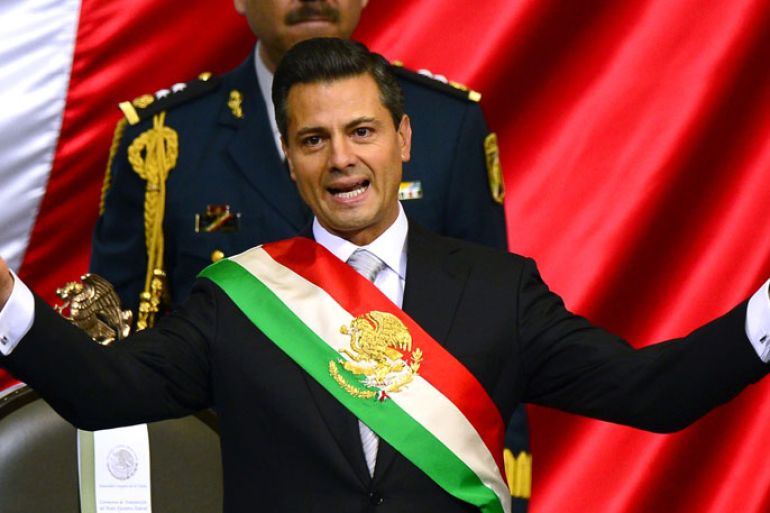 Mexican new President Enrique Pena Nieto speaks after taking the constitutional oath during a ceremony at the Congress in Mexico City, on December 1, 2012. Enrique Pena Nieto was sworn in as president of Mexico on Saturday following protests by leftist lawmakers inside the congress and clashes between demonstrators and police outside. AFP PHOTO/ALFREDO ESTRELLA