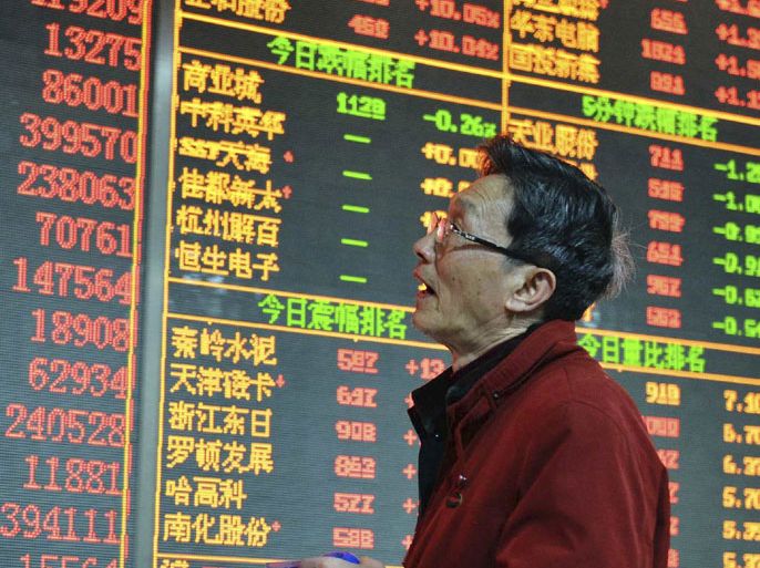 r : An investor looks at an electronic board showing stock information at a brokerage house in Hangzhou, Zhejiang province December 14, 2012. Chinese shares surged more than 4 percent on Friday as investors have high expectations for an annual economic conference that will set the tone for China's economic policies in 2013, Xinhua News Agency reported. REUTERS/China Daily (CHINA - Tags: BUSINESS) CHINA OUT. NO COMMERCIAL OR EDITORIAL SALES IN CHINA
