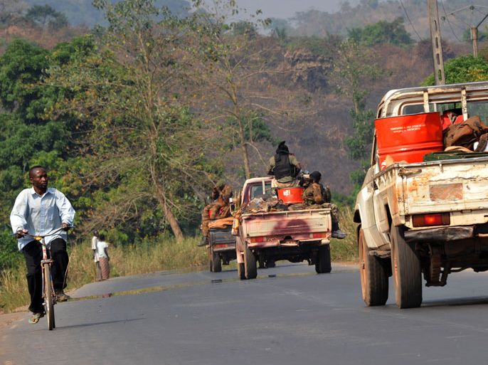 Centrafrican military convoy drives on a road going to Sibut, 160 km north of Bangui, on December 29, 2012. Sibut was seized by the rebel coalition Seleka on December 29. Authorities in the Central African Republic capital Bangui have imposed today a nighttime curfew as fighters from the rebel coalition move closer to the city, according to a government decree. AFP PHOTO/ SIA KAMBOU