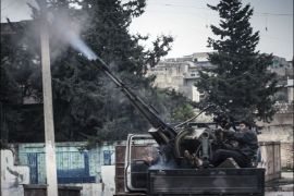 A Free Syrian Army fighter fires an anti-aircraft artillery weapon during an air strike in Binsh near Idlib December 23, 2012. Picture taken December 23, 2012. REUTERS/Muhammad Najdet Qadour/Shaam News Network/Handout (SYRIA - Tags: POLITICS CIVIL UNREST) FOR EDITORIAL USE ONLY. NOT FOR SALE FOR MARKETING OR ADVERTISING CAMPAIGNS. THIS IMAGE HAS BEEN SUPPLIED BY A THIRD PARTY. IT IS DISTRIBUTED, EXACTLY AS RECEIVED BY REUTERS, AS A SERVICE TO CLIENTS