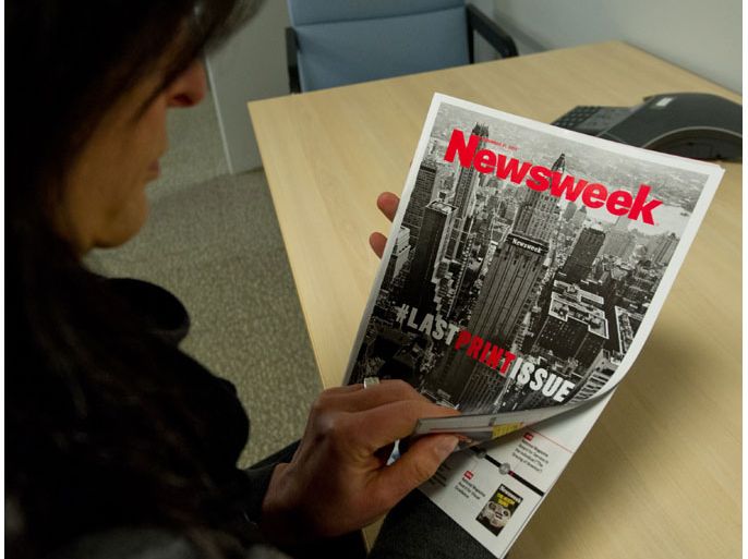 Washington, District of Columbia, UNITED STATES : This December 24, 2012 photo shows a woman perusing the final print edition of Newsweek in Washington, DC. Newsweek ends its 80-year run as a weekly news magazine with a final print edition published this week with a December 31, 2012 date. The magazine went with a vintage photo of its old Midtown Manhattan headquarters in New York for the cover shot and a Twitter hashtage headline of "#lastprintissue.” AFP PHOTO / Karen BLEIER