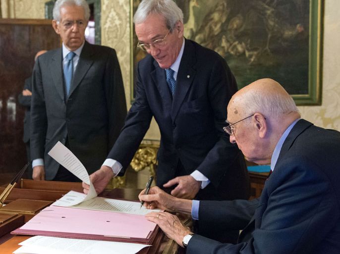 Italian President Giorgio Napolitano (R) signs the decree concerning the next electoral rallies, in his office at Rome's Quirinale palace on December 22, 2012 next to Prime Minister Mario Monti (L). Napolitano dissolved parliament today following Prime Minister Mario Monti's resignation, opening the way for a general election. Italy's election campaign kicked off amid uncertainty over whether Prime Minister Mario Monti will launch himself into the political fray and fight flamboyant billionaire Silvio Berlusconi for the top job