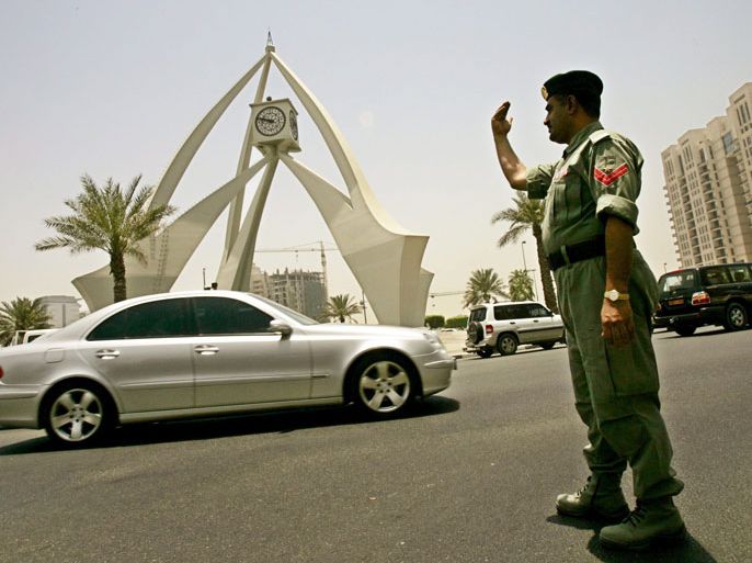 epa000453192 A traffic policeman directs vehicles at the Clocktower Traffic Circle in downtown Dubai, United Arab Emirates on Thursday, 9 June 2005. The entire city of Dubai, the UAE's largest city, lost power for about two hours today forcing police and private citizens to try and control traffic as temperatures soared above 40 degrees Celsius. The Clocktower's clock stopped at 9:50 AM, the time the city lost power. EPA/STEFAN ZAKLIN