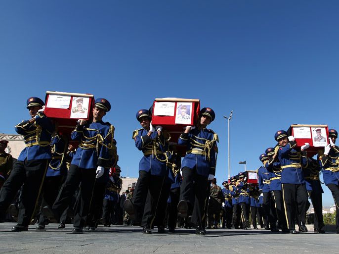 Sanaa, -, YEMEN : Honour guard soldiers carry the coffins of military officers during their funeral procession in Sanaa on December 10, 2012, who were killed in an ambush on December 8. Four officers were killed, including General Nasser Naji bin Farid, commander of military forces in central Yemen, and six soldiers wounded in the attack by armed men, near Marib, 140 kilometres east of Sanaa, blamed on Al-Qaeda. AFP PHOTO/ MOHAMMED HUWAIS