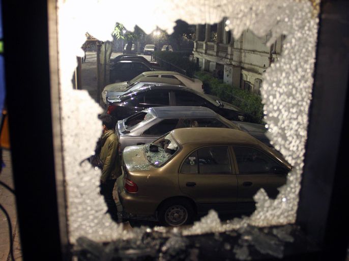 EGYPT : A damaged cars is seen through a smashed window in Cairo on December 15, 2012, after hundreds of Islamists stormed al-Wafd political party headquarters on the day of the referendum. Al-Wafd party announced on its website that it had been attacked by supporters of the Salafist preacher Hazem Salah Abou Ismail. AFP PHOTO/STR
