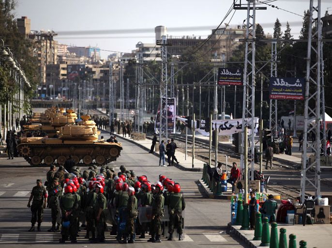 afp : Tanks belonging to the Egyptian Republican Guard and members of the military police deploy outside the presidential palace in Cairo on December 11, 2012. Protesters started to gather in the Egyptian capital for rival rallies for and against a divisive constitutional referendum proposed by President Mohamed Morsi. AFP PHOTO/PATRICK BAZ