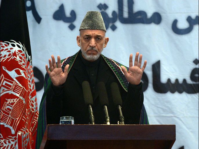Afghanistan president Hamid Karzai talks during an 'Anti-Corruption' ceremony at the Amani High School in Kabul on December 22, 2012. Karzai on December 22 accused foreign countries for a big part of corruption in his country, ranked one of the most corrupt in the world. Marking the international anti-corruption day in Kabul, Karzai said the corruption in his administration was smaller compared to corruption involving foreigners in Afghanistan. AFP PHOTO/Massoud HOSSAINI