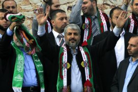 GAZA CITY, GAZA STRIP, - : Hamas leader in exile Khaled Meshaal (C) waves to the crowds as Hamas prime minister in the Gaza Strip Ismail Haniya (L) stands by, during a rally to mark the 25th anniversary of the founding of the Islamist movement, in Gaza City on December 8, 2012. Meshaal made his first visit to Gaza, timed to coincide with the 25th anniversary of the Islamist movement's founding. AFP PHOTO/ SAID KHATIB