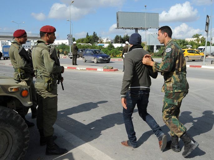 Caption:A Tunisian soldier detains a man after security forces deployed on roads leading to the Douar Hicher quarter of Manouba, a Salafist hotspot near Tunis, on November 2, 2012. Tunisian troops and police deployed ahead of the main Muslim weekly prayers outside a flashpoint suburb of the capital, just days after a deadly attack by Salafist militants on national guards posts.
