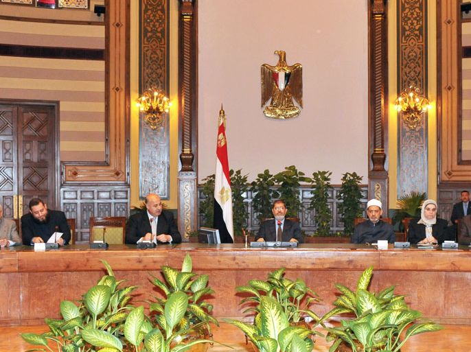 handout picture released by the Egyptian presidency on December 8, 2012, shows Egyptian President Mohamed Morsi (Top C) meets with Sunni Islam's top authority and the head of Cairo's Al-Azhar university, Sheikh Mohammed Sayyed Tantawi (4th R) and other politicians