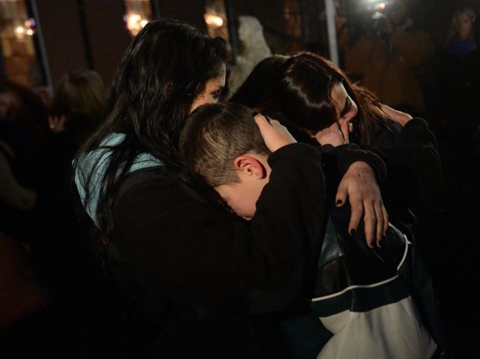 gather for a prayer vigil at St Rose Church following an elementary school shooting in Newtown, Connecticut, December 14, 2012. A young gunman slaughtered 20 small children and six teachers on Friday after walking into a school in an idyllic Connecticut town wielding at least two sophisticated firearms