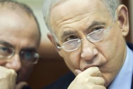 JERUSALEM, -, - : Israeli Prime Minister Benjamin Netanyahu (R) looks over as as he attends the weekly cabinet meeting in his Jerusalem office, on December 23, 2012. Netanyahu on December 22, welcomed the nomination of Senator John Kerry to replace Hillary Clinton as US secretary of state,