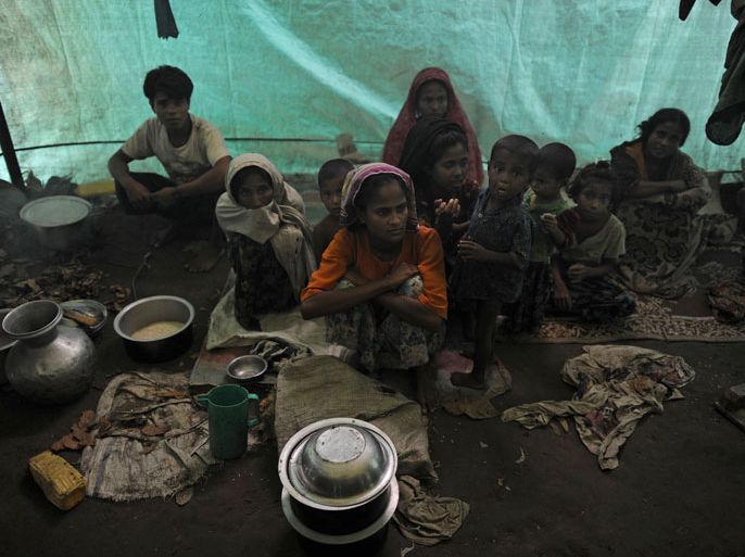 This file picture taken on October 10, 2012 shows Muslim Rohingyas sitting inside their collective tent at the Dabang Internally Displaced Persons (IDP) camp, located on the outskirts of Sittwe, capital of Myanmar's western Rakhine state. The UN's humanitarian chief Valerie Amos has described conditions for thousands of displaced Muslim Rohingya in western Myanmar as "dire" and said both Muslim and Buddhist communities are living in fear. AFP PHOTO / Christophe ARCHAMBAULT / FILES