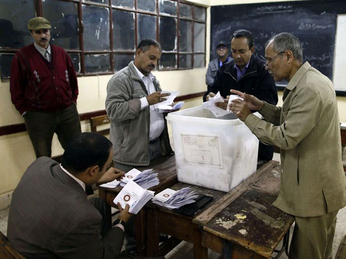 Polling station officials count ballots in Cairo on December 15, 2012 at the end of the first day of vote in a referendum on a new constitution. Tensions were rising late on December 15 over a divisive new constitution being put to Egyptian voters in the first round of a referendum pushed through by President Mohamed Morsi despite weeks of opposition protests