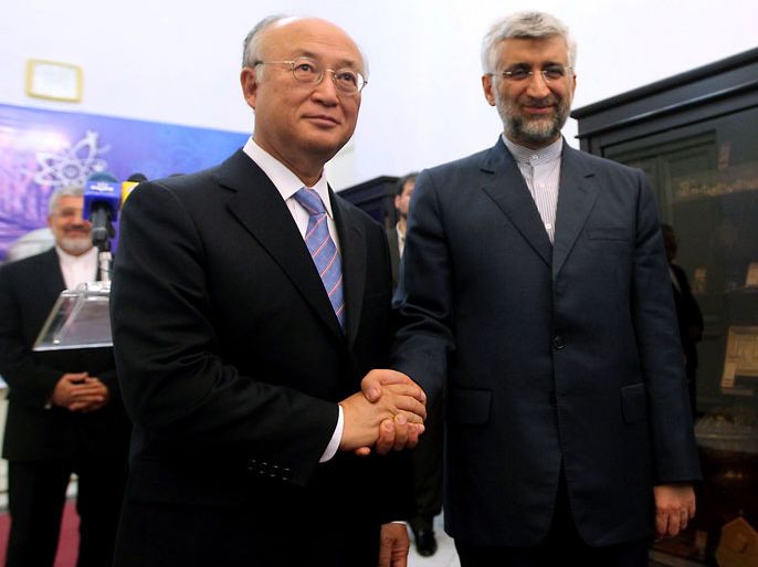 file picture taken in Tehran on May 21, 2012 shows Iran's chief nuclear negotiator Said Jalili (R) shaking hands with International Atomic Energy Agency (IAEA) chief Yukiya Amano during his official visit. The UN atomic agency, International Atomic Energy Agency (IAEA), will travel to Tehran on December 13, 2012 to re-start diplomatic efforts to resolve the Iranian nuclear crisis