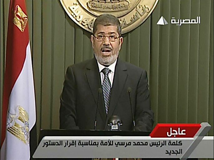 An image grab taken from Egyptian state TV shows Egyptian President Mohamed Morsi as he gives an address on December 26, 2012, in Cairo, after signing into law a contentious constitution he and Islamist allies backed to the fury of the opposition and to international concern. AFP PHOTO/EGYPTIAN TV ==RESTRICTED TO EDITORIAL USE - MANDATORY CREDIT "AFP PHOTO / EGYPTIAN TV" - NO MARKETING NO ADVERTISING CAMPAIGNS - DISTRIBUTED AS A SERVICE TO CLIENTS ==
