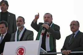 Turkish Prime Minister Recep Tayyip Erdogan (2ndR) flanked by with President of the National Coalition for Syrian Revolutionary and Opposition Forces Ahmed Moaz al-Khatib (3rdR) speaks to the audience during a meeting at Akcakale Refugee camp on December 30, 2012, in Urfa. International peace envoy for Syria Lakhdar Brahimi warned that the Syrian war was worsening "by the day" as he announced a peace plan he believed could find support from world powers, including key Syria ally, Russia. AFP PHOTO/STR