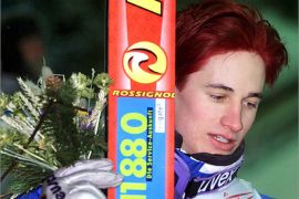 German jumping star Martin Schmitt leaves the podium with coloured hair after winning with the German team the ski-jumping team K 116 competition at the Nordic World Ski Championships in Lahti, Finland, Saturday 24th February 2001.