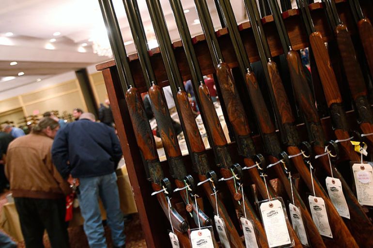 A row of shotguns are seen during the East Coast Fine Arms Show in Stamford, Connecticut, January 5, 2013. The show is being held despite the mayor's plea that the event not be held so soon after last month's massacre at an elementary school in nearby Newtown. REUTERS/Carlo Allegri (UNITED STATES - Tags: SOCIETY)