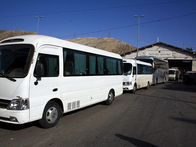 Buses transporting Russians from Syria arrive at the Masnaa Lebanese border crossing on January 22, 2013. Up to 150 Russians are preparing to flee the bloodshed in Syria over the next two days on board two planes sent to Beirut from Moscow, a Russian diplomat told AFP. AFP PHOTO / STR