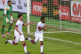 Qatar's Khalfan Ibrahim (R) celebrates his goal with teammate Jaralla Ali during their Gulf Cup tournament soccer match against Oman at Isa Sports City in Isa Town January 8, 2013. REUTERS/Tariq AlAli (BAHRAIN - Tags: SPORT SOCCER)