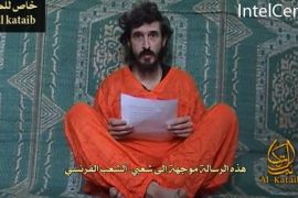 French hostage Denis Allex is seen in this frame grab. An Islamist group in Somalia has issued a video of Allex, held in the Horn of Africa country, showing him asking France to meet his captors' demands. A copy of the video issued by U.S.-based SITE Intelligence Group, which monitors militant internet traffic, shows the captive in an orange outfit with armed men standing behind him while he reads a statement in French.