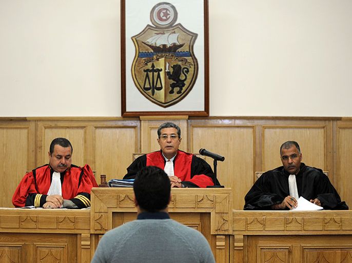 Ayoub Messaoudi (front), former adviser of Tunisian President, faces judges during his trial on appeal at a military court on January 4, 2013 in Tunis. Messaoudi, former adviser of Moncef Marzouki, was handed a four-month suspended jail term in September 2012 for defaming the army and "denigrating a military institution". AFP PHOTO / FETHI BELAID