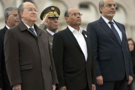 Tunisian President Moncef Marzouki (C), Tunisian Parliament Speaker Mustapha Ben Jaafar (L) and Prime Minister Hamadi Jebali (R) review troops during an official ceremony marking the second anniversary of the uprising that ousted long-time dictator Zine El Abidine Ben Ali on January 14, 2013 in Tunis. A deadlock over a new constitution and the growing influence of radical Islamists are further challenges facing the nation since Ben Ali fled to Saudi Arabia. AFP PHOTO / FETHI BELAID