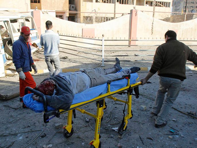 Medical personnel attend to the body of a victim at the site of a suicide bomb attack in Kirkuk, 250 km (155 miles) north of Baghdad, January 16, 2013