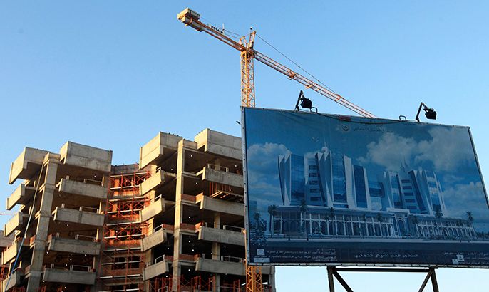 A billboard advertising an administrative office complex project is erected in front of the construction site in Benghazi January 19, 2013. Unlike the capital Tripoli, Benghazi, Libya's second-biggest city, has few modern high-rise developments. The development of many construction projects is being promoted as Benghazi bids to regain its former status as the country's business capital and end what local residents see as decades of marginalisation. Picture taken January 19, 2013. To match Mideast Money LIBYA-BENGHAZI/ REUTERS/Esam Al-Fetori (LIBYA - Tags: REAL ESTATE BUSINESS POLITICS CONSTRUCTION)