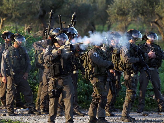 Israeli soldiers fire teargas during clashes at the funeral of Samir Ahmed Awad, 17, in the West Bank village of Budrus on January 15, 2013. Israeli troops shot dead a Palestinian teenager near the separation barrier in the northern West Bank on Tuesday, Palestinian medical and security sources told AFP. AFP PHOTO/ABBAS MOMANI