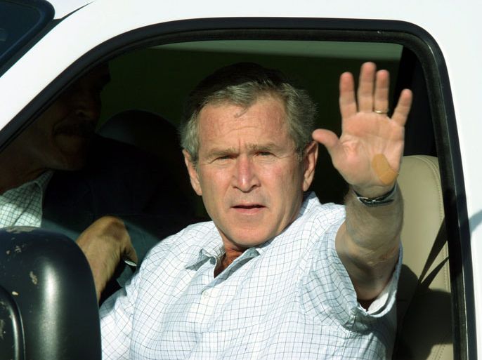 epa00148084 U.S. President George W. Bush waves from his pickup truck as he arrives at a welcoming ceremony for Mexico's President Vincente Fox