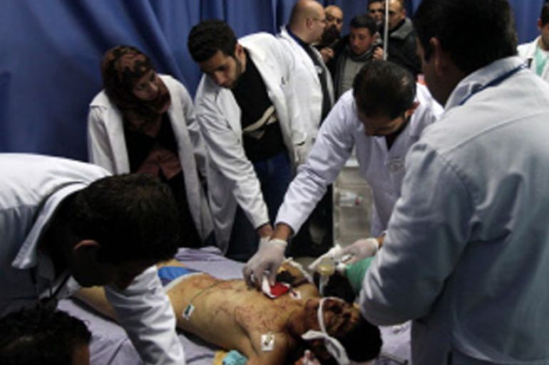 Doctors look at the body of Samir Ahmed Awad, 17, who was shot by Israeli troops not far from Israel’s controversial separation barrier, at a morgue near the West Bank city of Ramallah on January 15, 2013. Samir Ahmed Awad died after being hit by a bullet to the chest and another to the leg in an area not far from the village of Ras Karkar, some 10 kilometres (about six miles) northwest of Ramallah, Palestinian medical and security sources told AFP. AFP PHOTO / ABBAS MOMANI