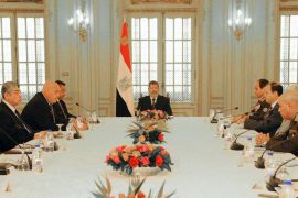 This handout picture released by the Egyptian Presidency shows Egypt's President Mohamed Morsi (C) during his meeting with the national defense council in Cairo on January 26, 2013.