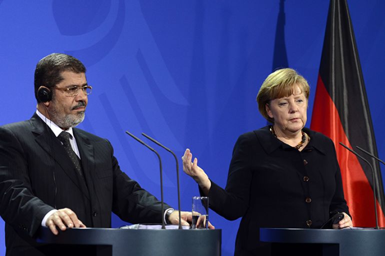 German Chancellor Angela Merkel and Egyptian President Mohamed Morsi give a joint press conference following a meeting at the Chancellery in Berlin on January 30, 2013. Morsi's visit will focus on bilateral cooperation as well as the situation in Egypt, where almost a week of violence has left more than 50 people dead, Egypt's official news agency MENA said.      AFP PHOTO / JOHN MACDOUGALL