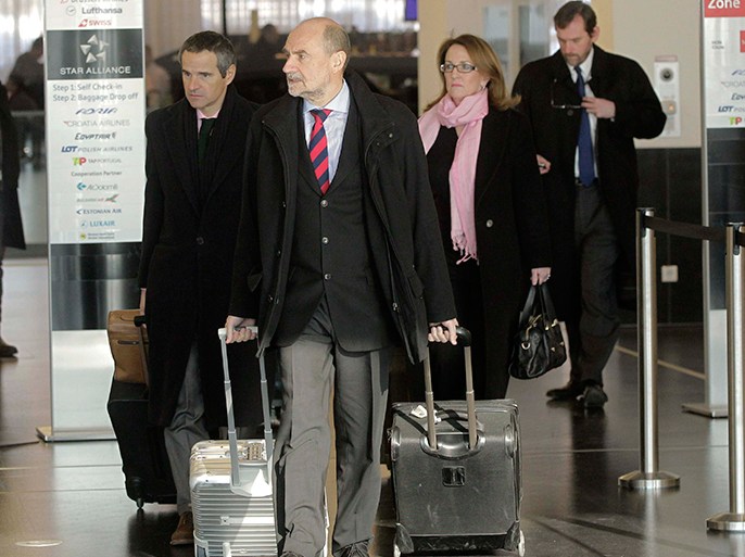 Herman Nackaerts (C) and members of a delegation of the International Atomic Energy Agency (IAEA) check-in before their departure to Iran, at the airport in Vienna January 15, 2013. A senior U.N. nuclear watchdog official said on Tuesday he was aiming for an agreement with Iran this week on a framework deal enabling his inspectors to investigate suspected nuclear bomb research. REUTERS/Herwig Prammer (AUSTRIA - Tags: POLITICS)