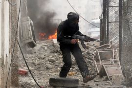 A Free Syrian Army fighter runs for cover in front of a burning barricade during heavy fighting in the Ain Tarma neighbourhood of Damascus January 30, 2013. REUTERS/Goran Tomasevic (SYRIA - Tags: CONFLICT CIVIL UNREST POLITICS)