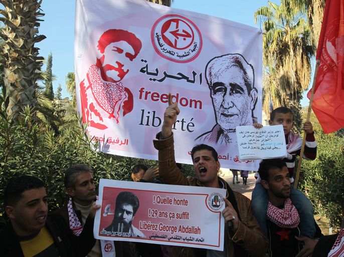 Palestinian supporters of the Popular Front for the Liberation of Palestine (PFLP) take part in a protest outside the French Cultural Center calling for the release of Lebanese militant Georges Ibrahim Abdallah (portrait L) and Ahmed Saadat, leader PFLP (portrait R), in Gaza City on January 21, 2013. AFP PHOTO/MAHMUD HAMS