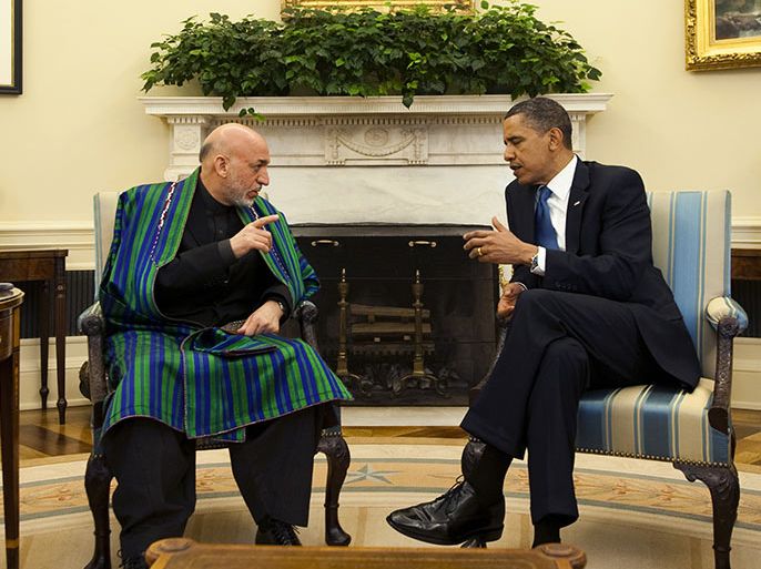 To go with Afghanistan-US-diplomacy-unrest,ADVANCER by Ben Sheppard FILES) In this photograph taken on May 12, 2010, US President Barack Obama speaks with Afghanistan President Hamid Karzai during a meeting in the Oval Office at the White House in Washington, DC. A key decision on how many US troops will stay on in Afghanistan after 2014 could be made next week at talks between President Barack Obama and Afghan leader Hamid Karzai in Washington, officials say. AFP PHOTO/Jim WATSON/FILES