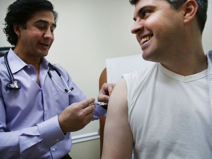 NEW YORK, NY - JANUARY 10: Aaron Lemma recieves a flu shot by Dr. Sassan Naderi at the Premier Care walk-in health clinic which administers flu shots on January 10, 2013 in New York City. The Flu season has hit parts of the country particularly hard this year with Boston declaring a public health emergency and a Pennsylvania hospital constructing a tent to handle excess flu cases.According to the Centers for Disease Control and Prevention, 22,048 flu cases have been reported from September 30 through the end of 2012. Spencer Platt/Getty Images/AFP==