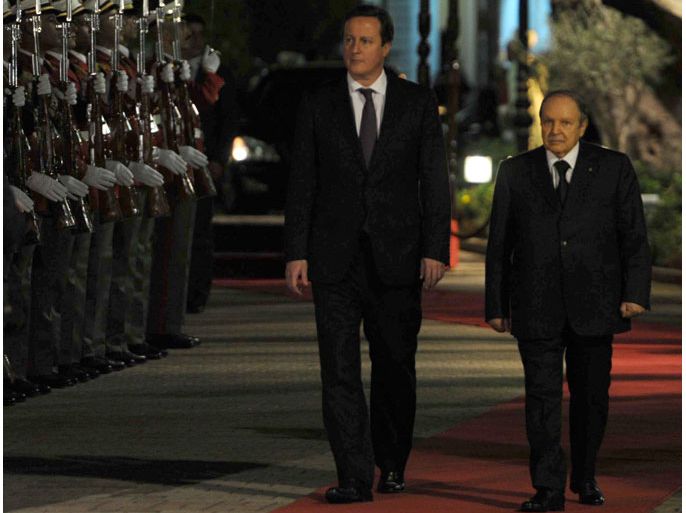 Algeria's President Abdelaziz Bouteflika (R) inspects the honor guard along side British Prime Minister David Cameron on January 30, 2013, in Algiers. Cameron flew into Algeria in the wake of this month's hostage crisis at a gas plant deep in the Sahara in which several Britons were killed