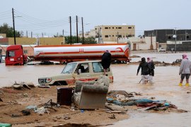 People wade down a flooded street after heavy rain in Tabuk, 1500 km (932 miles) from Riyadh January 28, 2013. REUTERS/Mohamed Alhwaity (SAUDI ARABIA - Tags: ENVIRONMENT)