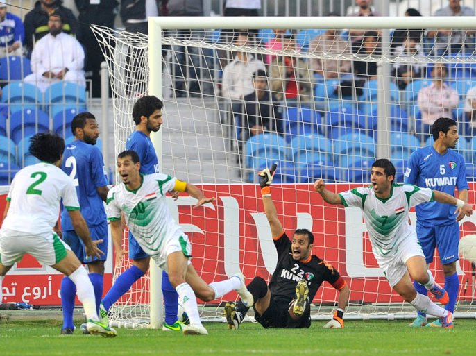 Iraq's Younes Mahmoud (yellow armband) celebrates after scoring a goal against Kuwait during their Gulf Cup tournament soccer match at Khalifa Sports City in Isa Town January 9, 2013. REUTERS/Tariq AlAli (BAHRAIN - Tags: SPORT SOCCER)