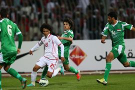 Emirati player Omar Abdul Rahman (C) dribbles past Humam Tariq Faraj ( back) Salam Shaker (R) and Ali Adnan al-Tameemi of Iraq during their 21st Gulf Cup football match final in Manama, on January 18, 2013.
