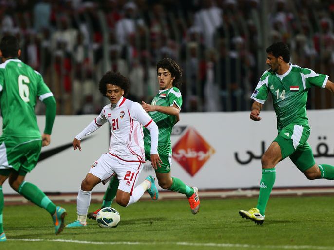Emirati player Omar Abdul Rahman (C) dribbles past Humam Tariq Faraj ( back) Salam Shaker (R) and Ali Adnan al-Tameemi of Iraq during their 21st Gulf Cup football match final in Manama, on January 18, 2013.