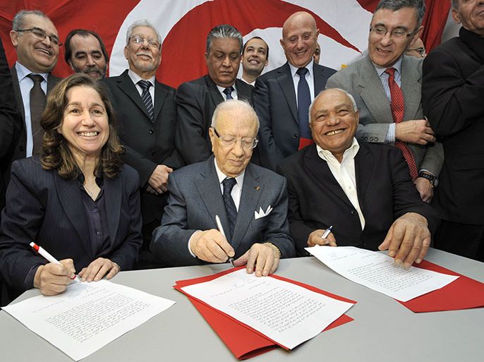 Tunisian former prime minister Beji Caid Essebsi (C) signs with the general secretary of the Republican party "Aljoumhouri" Maya Jerbi (L) and Ettajdid party General Secretary Ahmed Brahim (R) a tripartite pact of union and announcing the creation of front of the "Union for Tunisia" on January 29, 2013 in Tunis. Highlighting the failures and shortcomings of the government to the Troika, the signatories forming the front, stated in their agreement "in order to cope with the difficult situation of the country and insecurity and to create a balance between the political forces, it was decided to create a political front and electoral uniting the three signatory parties and remains open to other parties will join the front." AFP PHOTO / FETHI BELAID