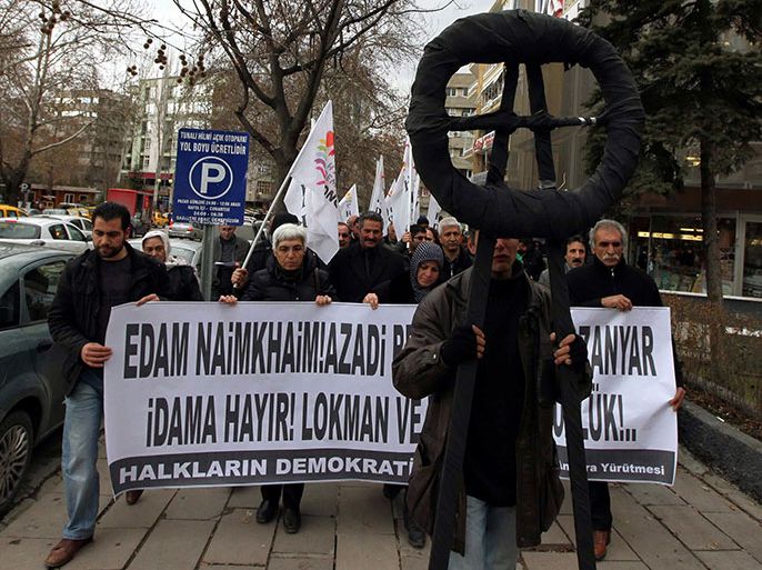 People march on January 29, 2013 to the Iranian Embassy in Ankara to protest against the conviction of two jailed Kurdish politicians, brothers Lokman and Zanyar Muradi, in Iran. Banner reads: " No to the death penalty. Freedom for Lokman and Zanyar!" AFP PHOTO / ADEM ALTAN