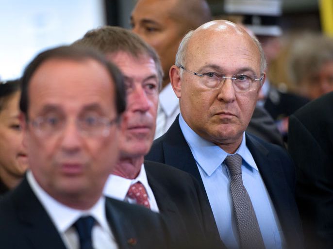 epa03245288 France s Labour minister Michel Sapin (R) listens to France s President Francois Hollande (L) delivering a speech during a visit at the Supratec headquarters in Bondoufle outside Paris France 01 June 2012. EPA/BERTRAND LANGLOIS/POOL MAXPPP OUT
