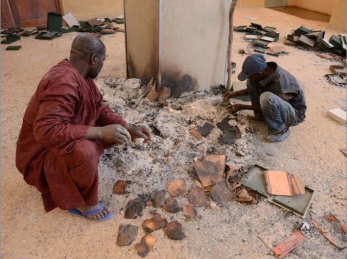 Men sort through the rubble at the Ahmed Baba Institute in Timbuktu, Mali. (Eric Feferberg / AFP/Getty Images / January 29, 2013)